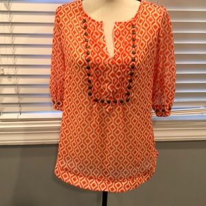 Orange and white shirt.